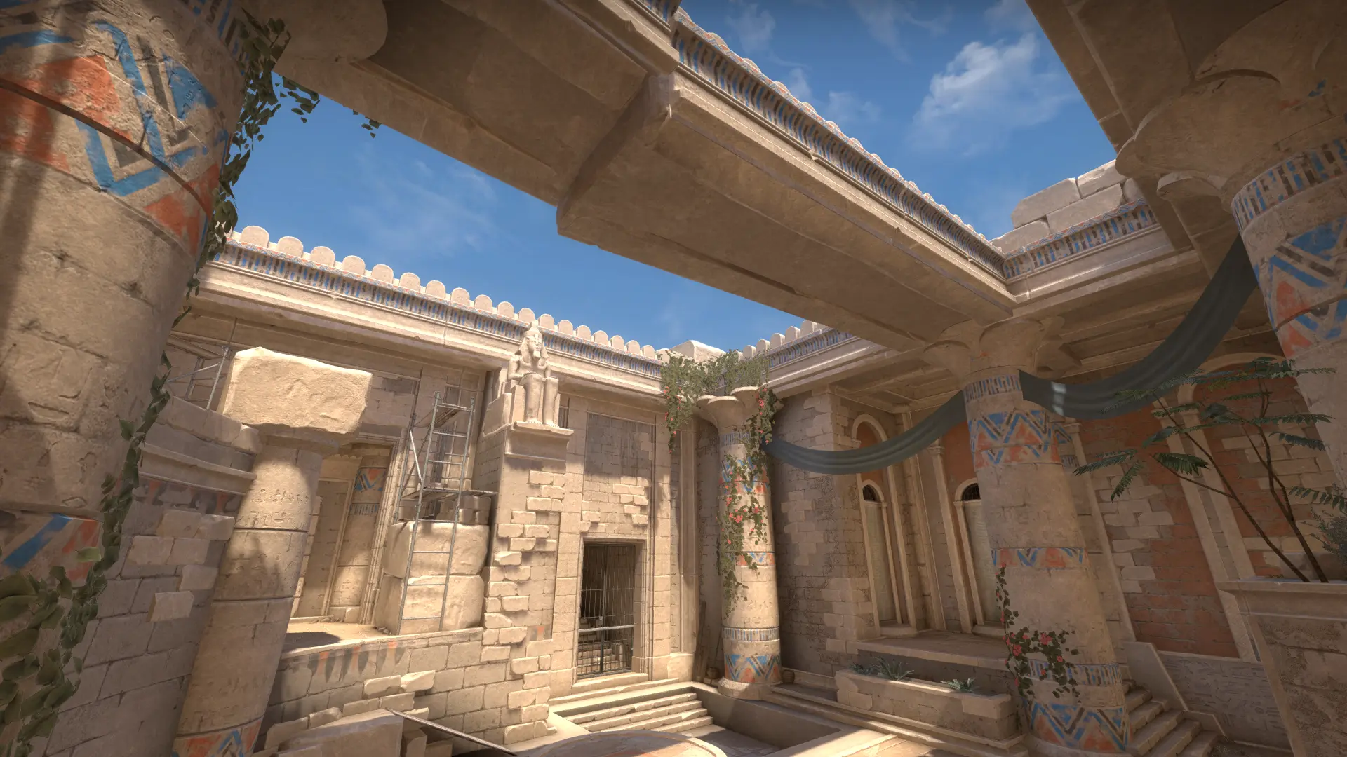 Open temple courtyard framed by painted columns and stone beams