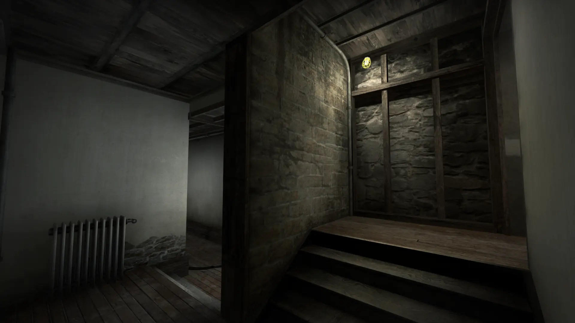 Interior hallway with a radiator, stone wall and wooden staircase